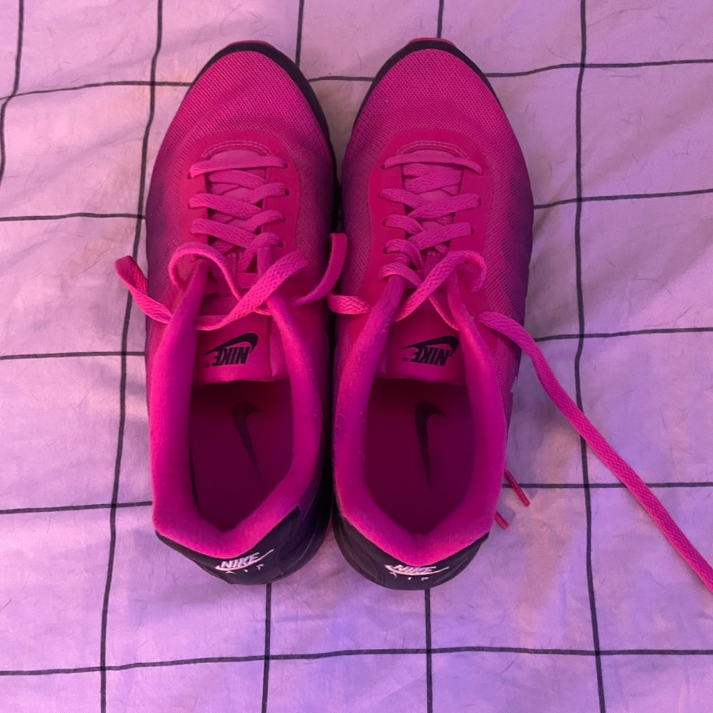 Pink and black Nike tennis shoes